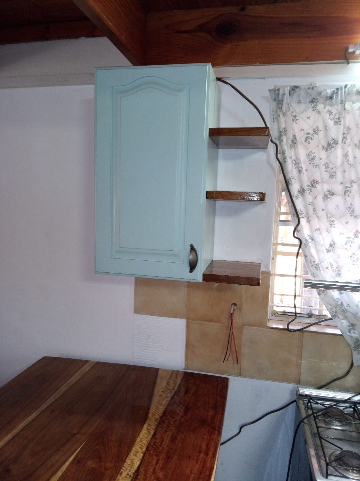 Complete cottage kitchen view with mint cabinets and wood details