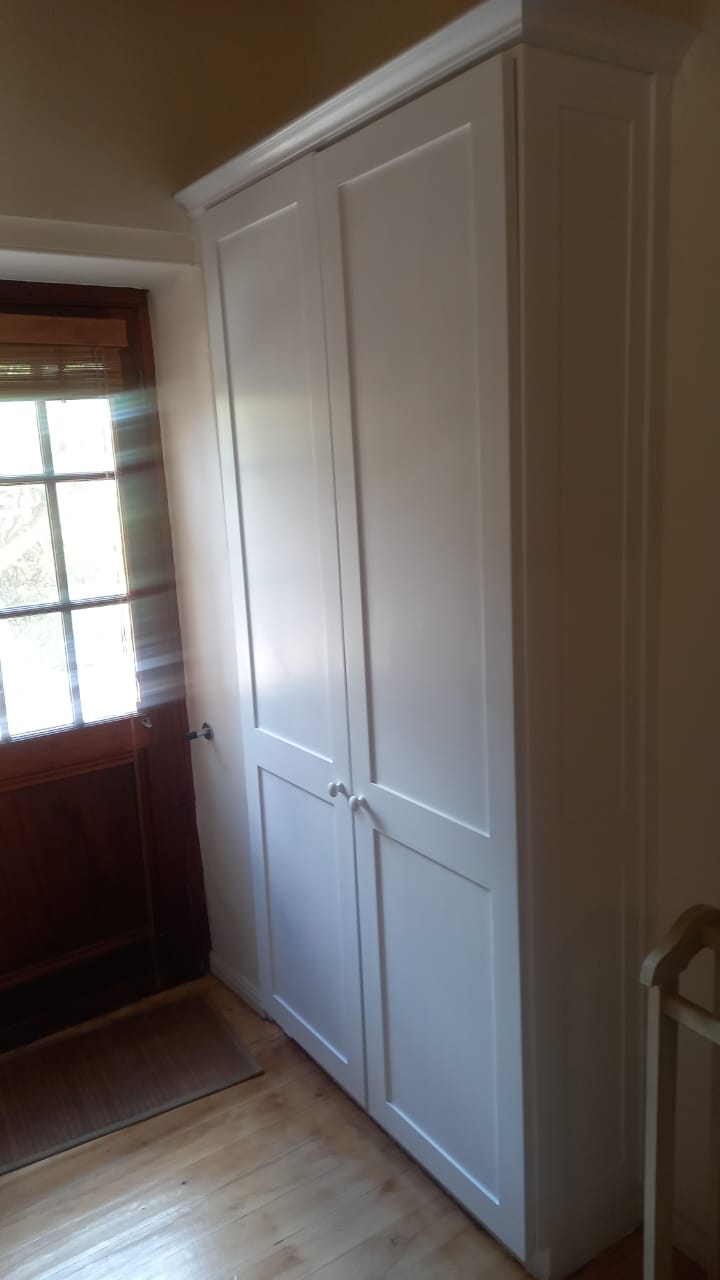 Close-up view of beadboard door detail and white knob hardware