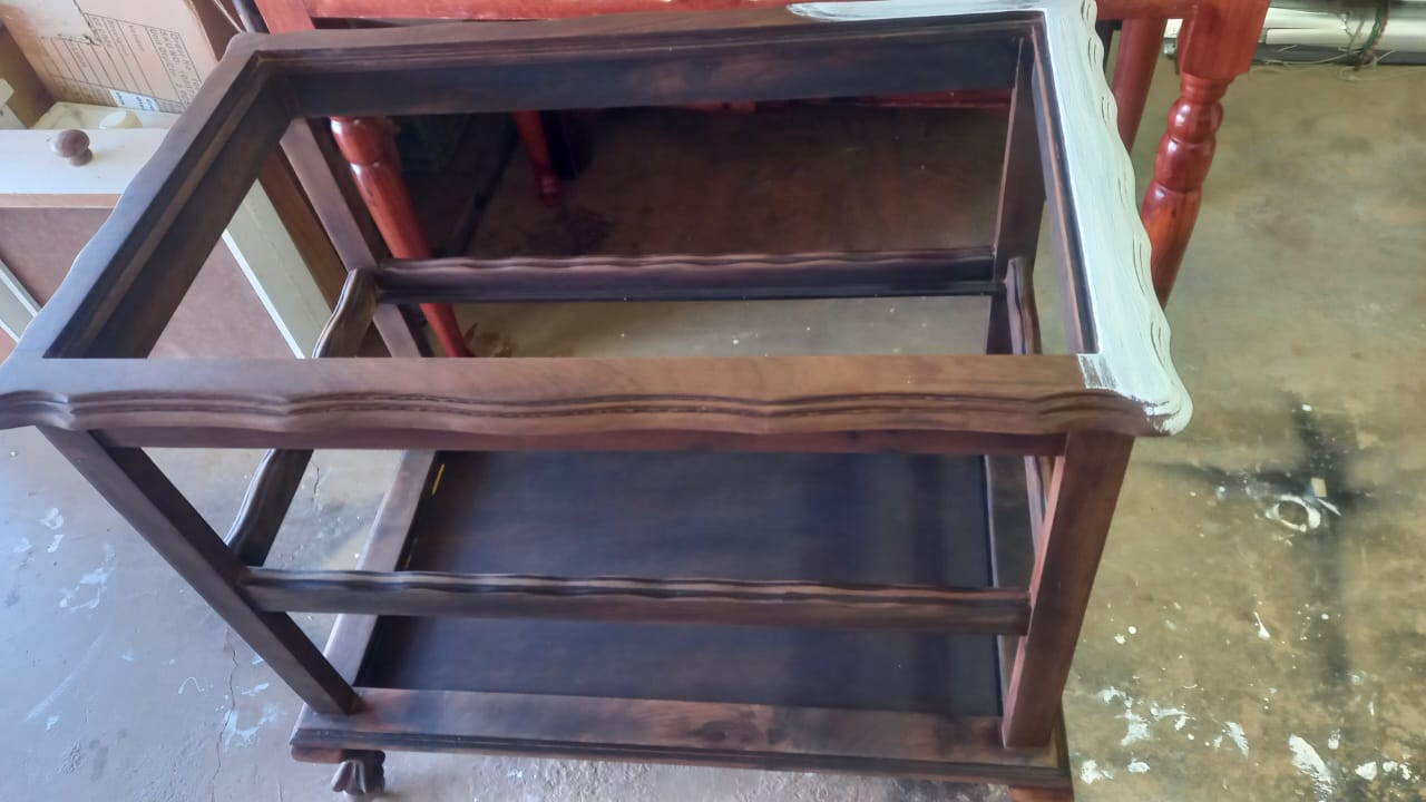 Original dark wood finish bar cart in workshop before refinishing